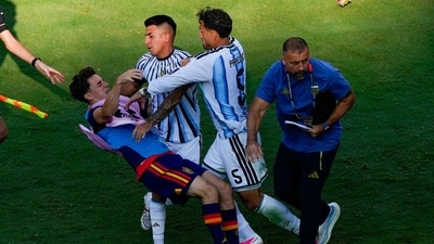 Spain's Gavi falls as he scuffles with Argentina's Leandro Paredes (5) and Thiago Almada after World Cup final. Spain's Gavi falls as he scuffles with Argentina's Leandro Paredes (5) and Thiago Almada after World Cup final.