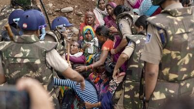 Security personnel remove protesters from the banks of the Barana river, bringing a 15-day agitation against the Ken-Betwa Link and other development projects to an end, in Chhatarpur, Madhya Pradesh, on Sunday. (PTI) Security personnel remove protesters from the banks of the Barana river, bringing a 15-day agitation against the Ken-Betwa Link and other development projects to an end, in Chhatarpur, Madhya Pradesh, on Sunday. (PTI)