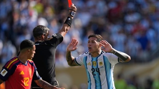 Referee Slavko Vincic, of Slovenia, shows a red card to Argentina's Enzo Fernandez (24) during the World Cup final soccer match between Spain and Argentina in East Rutherford, N.J., near New York, Sunday, July 19, 2026. (AP Photo/Frank Franklin II)