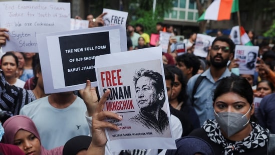 Supporters of the Cockroach Janta Party (CJP) in Mumbai hold posters of Sonam Wangchuk a day after authorities in Delhi moved him to a hospital during his hunger strike, during a protest demanding the resignation of education minister Dharmendra Pradhan.