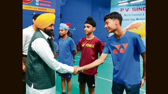 Punjab chief minister Bhagwant Mann interacting with badminton players at Raizada Hansraj Stadium in Jalandhar. (HT Photo)