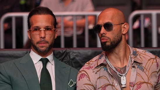 Andrew Tate, right, and his brother Tristan arrive an event, April 11, 2026, in Miami.
