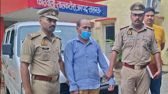 The accused, Girish Mishra, in police custody. (Sourced)