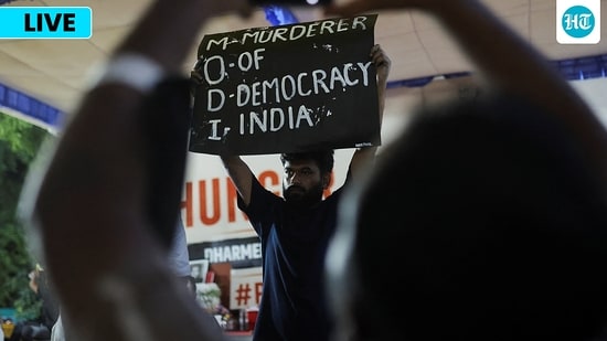 Abhijeet Dipke, head of the Cockroach Janta Party (CJP), holds a banner during an indefinite hunger strike after authorities took Sonam Wangchuk(REUTERS)