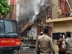 Firefighters douse the blaze on the fourth floor of the building at the Jawahar Bhawan complex in Lucknow on Monday. (HT Photo)
