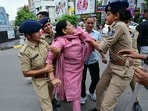 ఓ మహిళా నిరసనకారులను అదుపులోకి తీసుకున్న పోలీసులు..(AFP)