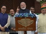 Prime Minister Narendra Modi, centre, arrives with members of his Cabinet to address the media outside Parliament House on the opening day of the monsoon session.