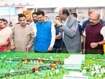 Pune, Jul 18 (ANI): Maharashtra Chief Minister Devendra Fadnavis, with Union Transport Minister Nitin Gadkari, inspects the mini models of the Pune-Shirur Upgraded Expressway, Talegaon-Chakan-Shikrapur Upgraded Expressway, and Hadapsar-Yavat Upgraded Expressway, in Pune on Saturday. State Deputy Chief Minister Sunetra Pawar and state minister Chandrakant Patil also present. (@CMOMaharashtra X/ANI Photo) (@CMOMaharashtra X)
