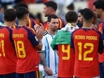 Spain players form a guard of honor for Argentina's Lionel Messi and teammates during the trophy presentation