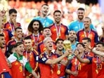 Spain's Dani Olmo lifts the trophy with teammates after winning the World Cup final against Argentina. (REUTERS)