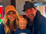 Children's creator Stevin John with his wife and son.