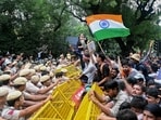 Activists and supporters of the Cockroach Janta Party (CJP) clash with police personnel during a protest demanding the resignation of India's Education Minister Dharmendra Pradhan over alleged NEET examination irregularities in New Delhi.