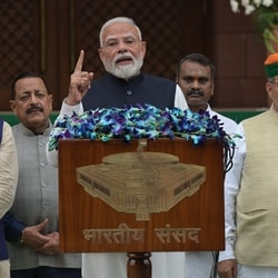 Prime Minister Narendra Modi, centre, arrives with members of his Cabinet to address the media outside Parliament House on the opening day of the monsoon session.