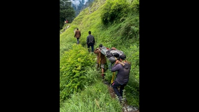 Mountaineering rescue team members carry an injured person on a stretcher along the trails of the Bada Bhangal, in Kangra on Monday. (PTI) Mountaineering rescue team members carry an injured person on a stretcher along the trails of the Bada Bhangal, in Kangra on Monday. (PTI)
