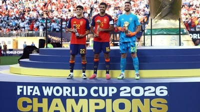 &nbsp;Rodri celebrates on the podium after winning the Golden Ball with Golden Glove winner Unai Simon and FIFA Young Player winner Pau Cubarsi following winning the World Cup. (REUTERS)