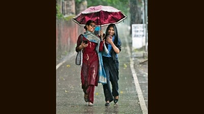 Two pedestrians seen sharing an umbrella amid the downpour in Chandigarh on Monday. (KESHAV SINGH/HT) Two pedestrians seen sharing an umbrella amid the downpour in Chandigarh on Monday. (KESHAV SINGH/HT)