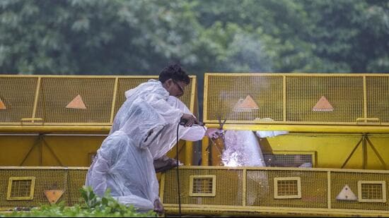 A worker carries out welding work on a barricade ahead of the Cockroach Janata Party's protest march at the Jantar Mantar in New Delhi on Monday. (PTI)