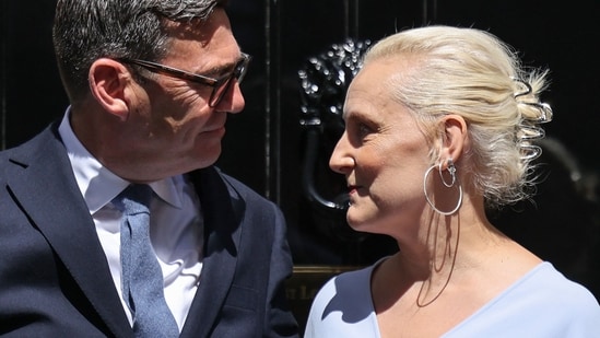 Britain's new Prime Minister Andy Burnham and his wife Marie-France van Heel pose on the steps of 10 Downing Street in central London on July 20, 2026, after being asked by the king to form the next government. (Photo by Henry NICHOLLS / AFP)