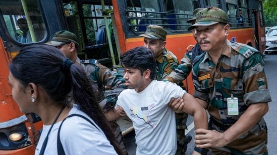 Security personnel detain a Cockroach Janata Party (CJP) supporter near the Parliament during a protest march, in New Delhi,&nbsp;(PTI)