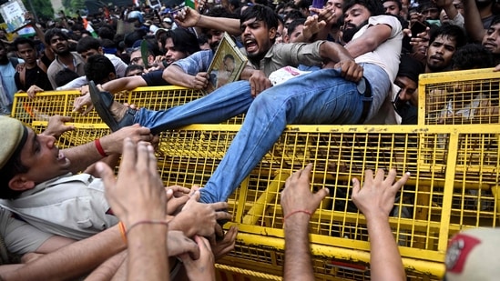 Activists and supporters of the Cockroach Janta Party (CJP) clash with police personnel during a protest march to the Parliament complex, demanding the resignation of education minister Dharmendra Pradhan over the NEET paper leak and other examination irregularities&nbsp;(AFP)