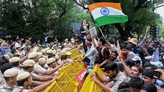 Activists and supporters of the Cockroach Janta Party (CJP) clash with police personnel during a protest demanding the resignation of India's Education Minister Dharmendra Pradhan over alleged NEET examination irregularities in New Delhi.