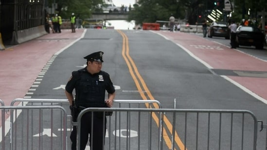 A New York Police Department (NYPD) officer near barricades blocking a street following reports of falling debris at 235 East 42nd Street. (Representational)