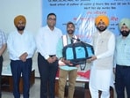 Cabinet minister Tarunpreet Singh Sond distributing kits to employees in Ludhiana on Monday. (HT Photo)