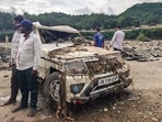 A damaged vehicle lies in a debris-strewn area following landslides and heavy rain, in Rajouri, Jammu and Kashmir.