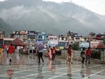 People walking during rain in Mandi on Monday. (Birbal Sharma/HT)