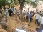 Villagers gathered at the abandoned well in Munimpur village in Jhajjar on Monday. (Manoj Dhaka/HT)