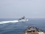 A Chinese warship sails near a U.S. destroyer in the Taiwan Strait in June 2023.