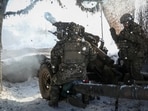 Ukrainian soldiers on the front line fire an L119 howitzer toward Russian troops.