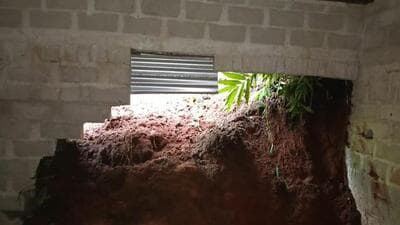 Part of the rain-soaked hill collapsed on Stolin Khimdet's house. (Image from HT source) Part of the rain-soaked hill collapsed on Stolin Khimdet's house. (Image from HT source)