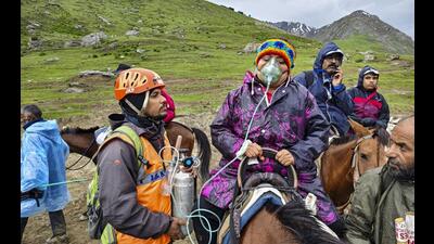 Mountain Rescue Team officials assist pilgrims during the annual Yatra. (PTI) Mountain Rescue Team officials assist pilgrims during the annual Yatra. (PTI)
