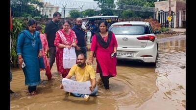 Residents stand in stagnant water, holding placards to protest civic neglect. (Sourced) Residents stand in stagnant water, holding placards to protest civic neglect. (Sourced)