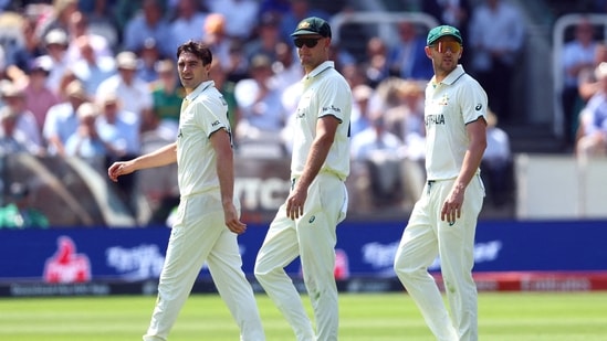 Pat Cummins walks back to the Lord's Pavilion with Josh Hazlewood.