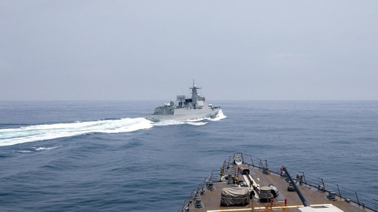 A Chinese warship sails near a U.S. destroyer in the Taiwan Strait in June 2023.