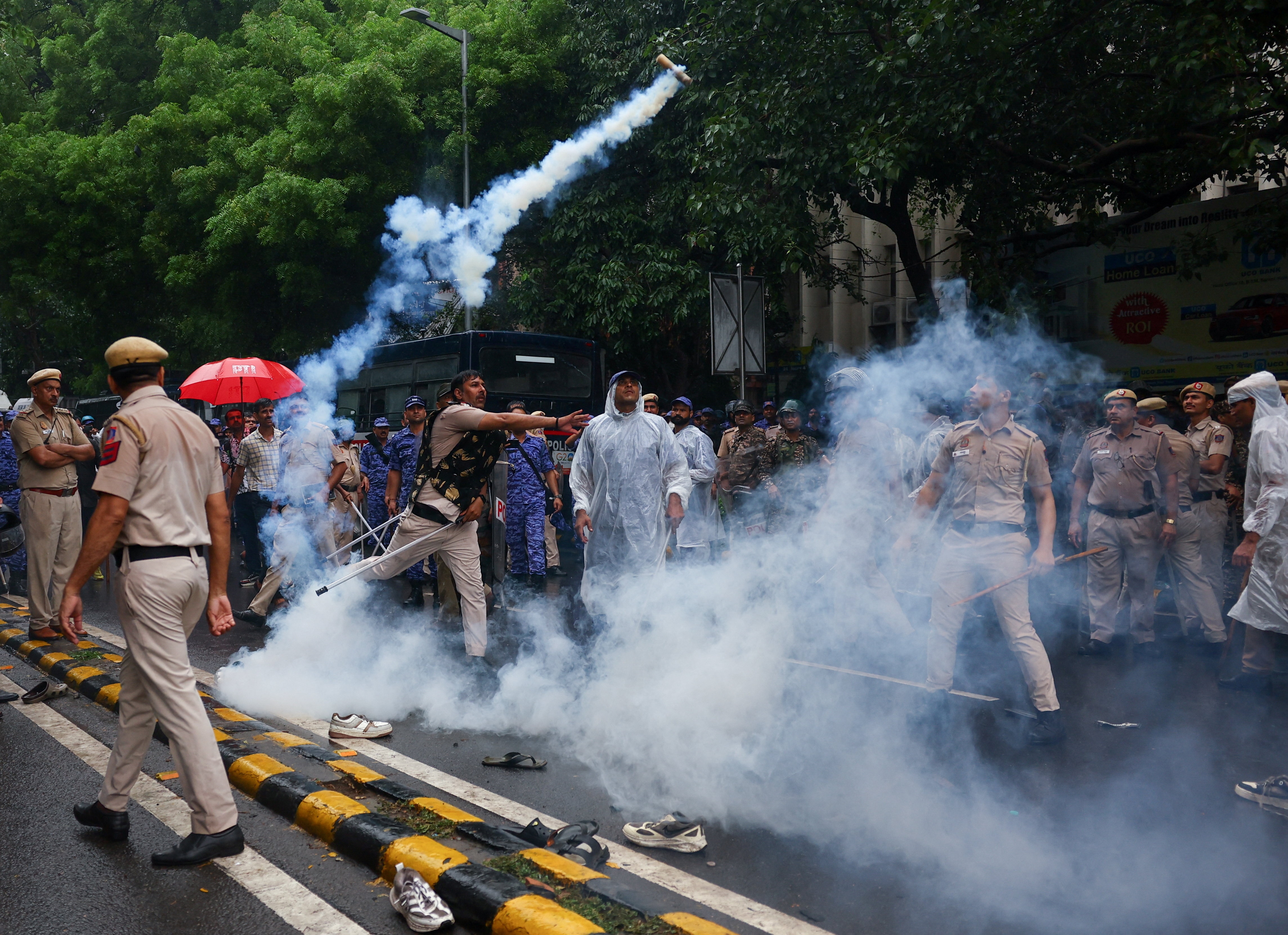 A police officer throws a tear gas canister towards protesters as supporters of India's Cockroach Janta Party demonstrate on the opening day of the Indian parliament's monsoon session, demanding the resignation of Education Minister Dharmendra Pradhan over exam paper leaks, in New Delhi, India, 20 July, 2026. (REUTERS)