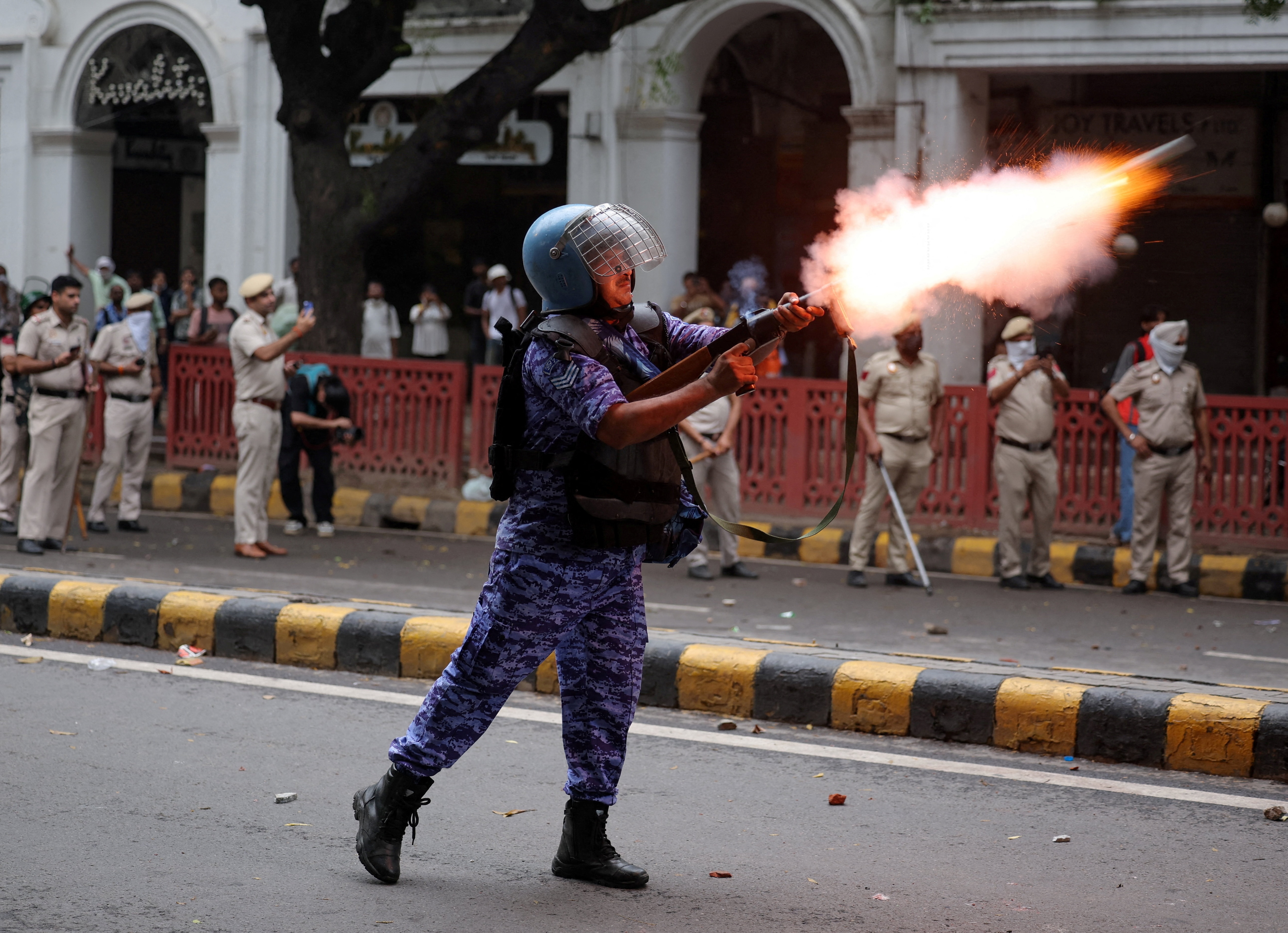 A member of the Rapid Action Force (RAF) fires a tear gas grenade towards protesters as supporters of India's Cockroach Janta Party demonstrate on the opening day of the monsoon session of the Indian Parliament, demanding the resignation of Education Minister Dharmendra Pradhan over exam paper leaks, in New Delhi, India, July 20, 2026. (Reuters)