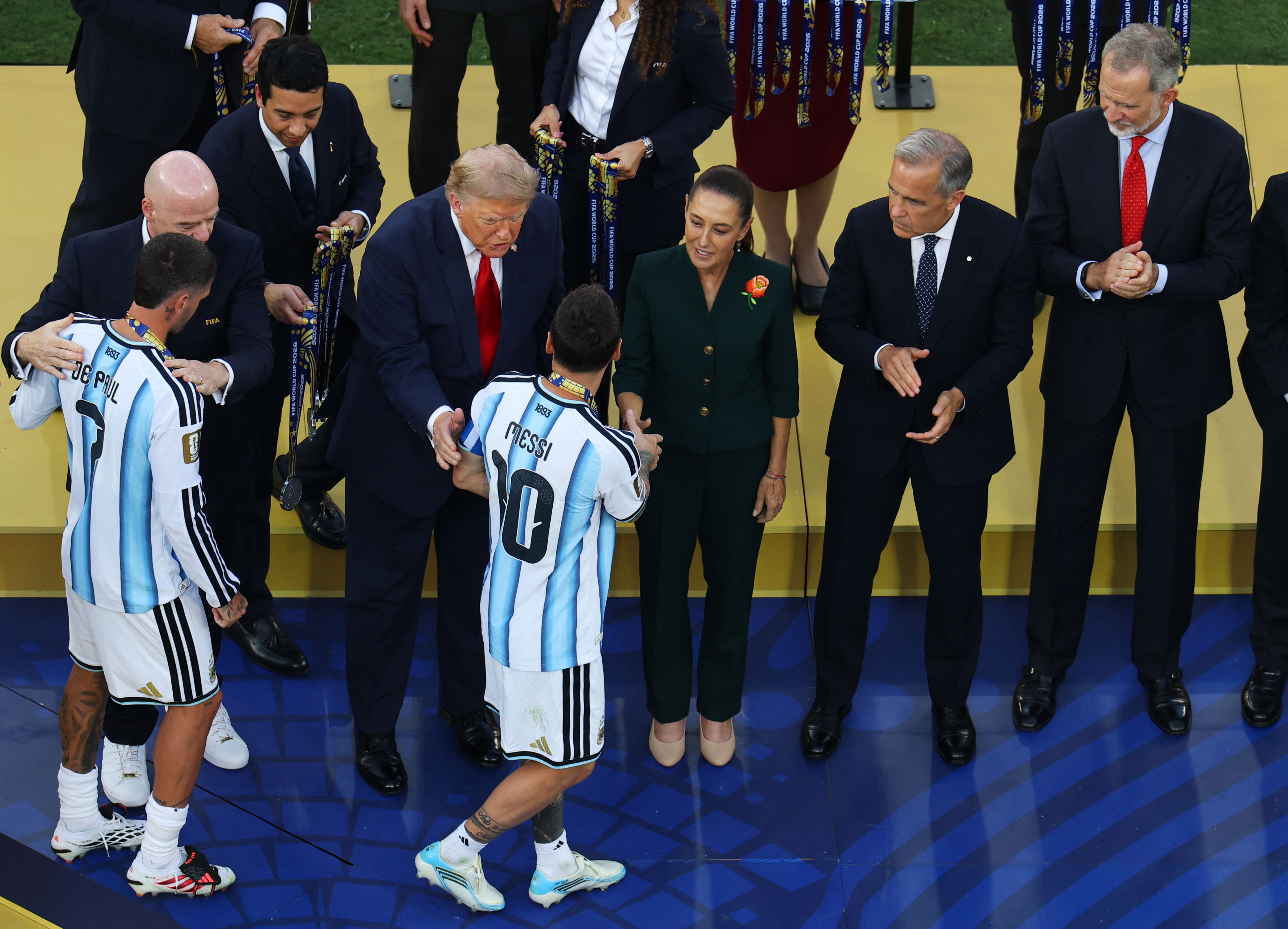 Argentina's Lionel Messi and Argentina's Rodrigo De Paul receive their World Cup runners up medal as US President Donald Trump, (REUTERS)