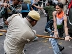 Security personnel stop Cockroach Janata Party (CJP) supporters as they raise slogans during a protest march, at Sansad Marg, in New Delhi.