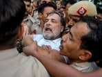 Security personnel detain Leader of Opposition in the Lok Sabha Rahul Gandhi during a sit-in protest near the Prime Minister's residence over alleged irregularities in the NEET examination.