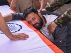 A family member mourns beside the tricolour-draped coffin of Head Constable Aashiq Hussain who was killed in a terrorist attack, in Anantnag,