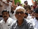 UP Congress president Ajay Rai sat on the road in protest after police stopped workers using barricades, in Lucknow on Wednesday. (Mushtaq Ali/HT)