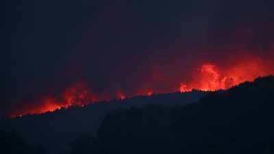 Fire rages in the hills near the village of Cotignac, France, during a wildfire on Tuesday, (Reuters)