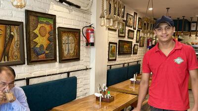 For the past year, Ayush Kumar has worked as a waiter at this neighbourhood café in Central Delhi. (HT Photo)