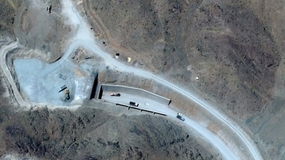 Vehicles at the western entrance of the Pickaxe Mountain tunnel complex adjacent to the Natanz Nuclear Facility near Natanz, Isfahan province, central Iran. (AFP) Vehicles at the western entrance of the Pickaxe Mountain tunnel complex adjacent to the Natanz Nuclear Facility near Natanz, Isfahan province, central Iran. (AFP)