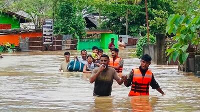NDRF personnel rescue flood-affected people in Assam.