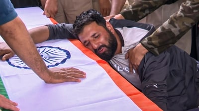 A family member mourns next to the tricolour-covered coffin of police chief Ashiq Hussain who was killed in a terror attack, in Anantnag, (PTI)