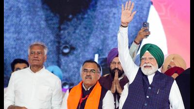 Prime Minister Narendra Modi waves to the crowd during a public meeting in Jalandhar.